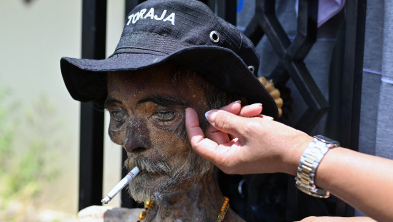 Festival socant pe o insula din Indonezia: Localnicii isi dezgroapa mortii, ii imbraca si le pun tigari aprinse in gura Imagine