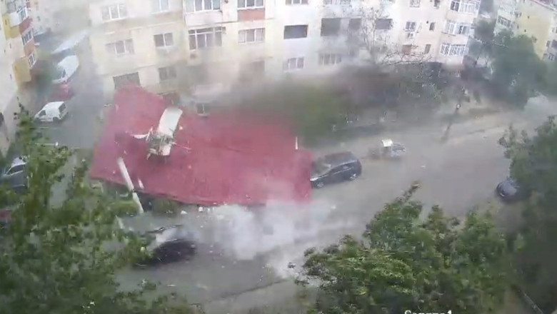 Momentul in care un om se salveaza la limita din calea unui acoperis smuls de vant, in timpul unei furtuni violente din judetul Dolj Imagine